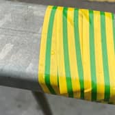 Why is there green and yellow tape on railings around Eastbourne? (photo from Eastbourne BID)