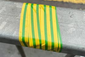 Why is there green and yellow tape on railings around Eastbourne? (photo from Eastbourne BID)