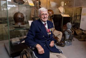 John Payne  at the Diving Museum, next to some of the equipment he wore. Picture: Habibur Rahman
