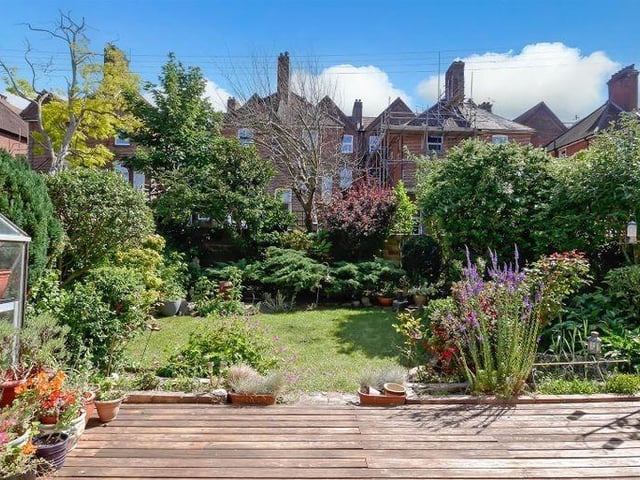 The garden has a decking area overlooking the lawn