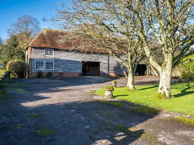 Adjacent to the farmhouse is a large traditional Sussex Barn