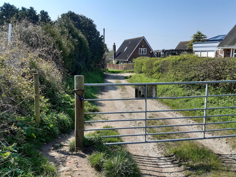 You pass by another metal gate