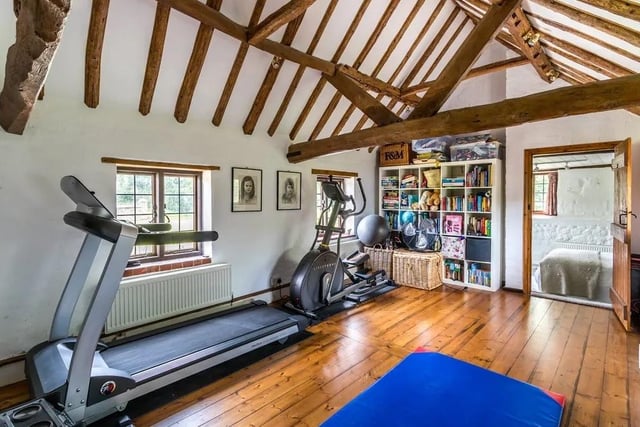 A large vaulted reception room is currently used as the family gym.
