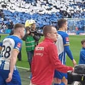 Ollie Heath walking out with Albion defender Adam Webster