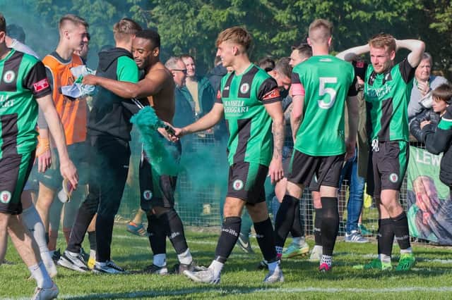 Burgess Hill Town players, fans and staff celebrate surviving in the Isthmian south east division at the end of their 0-0 draw with Beckenham
