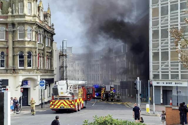 The fire has broken out in a building adjacent to the railway station and multiple fire crews are at the scene. Photo: Simon Offen