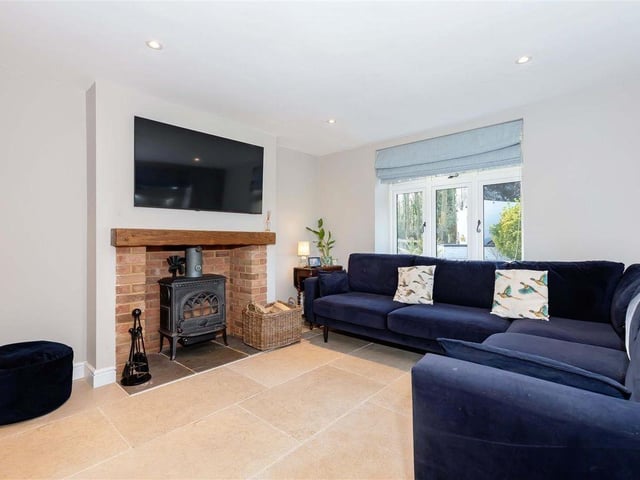 The double-aspect living room has a character fireplace