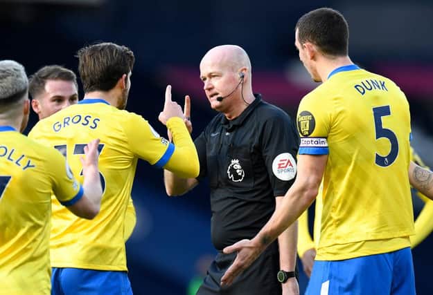Aaron Connolly, Pascal Gross and Lewis Dunk of Brighton and Hove Albion confront referee Lee Mason. (Photo by Peter Powell - Pool/Getty Images)