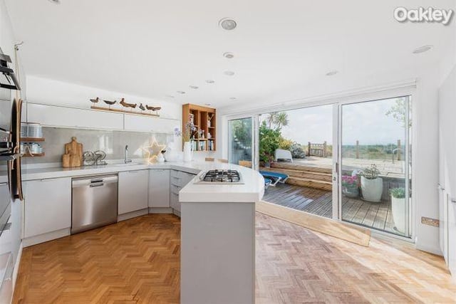 The 'Keller' kitchen provides a cool and contemporary space to entertain with a curved Corian work-top and breakfast bar offering views of the beach.