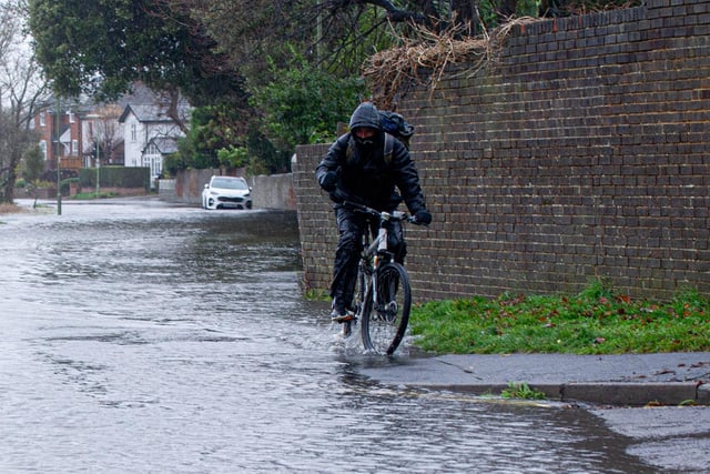 Cyclist riding through the flood  around Wallington, Fareham on Tuesday 7th December 2021. Picture: Habibur Rahman