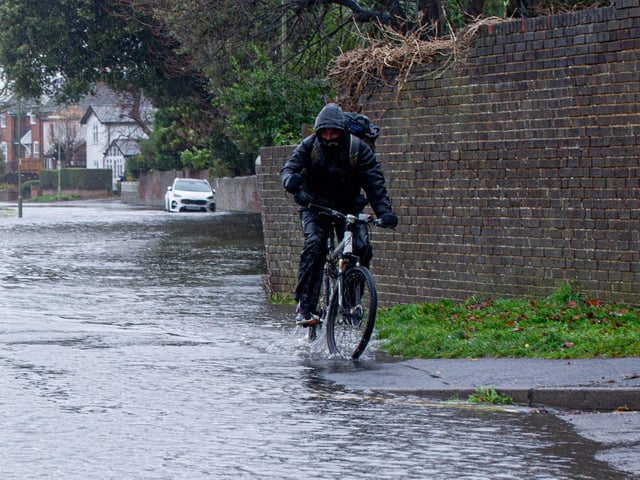 Cyclist riding through the flood  around Wallington, Fareham on Tuesday 7th December 2021. Picture: Habibur Rahman