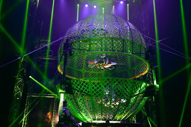 The riders travel at G-force speeds inside a mesh dome
