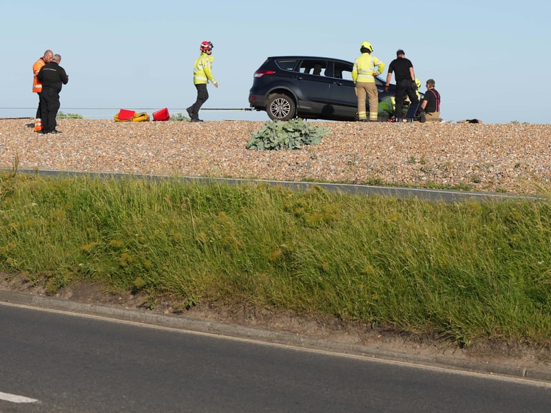 Police and the fire service helping at car on Worthing Beach on Monday evening, June 2