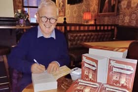 Michael signing copies of his book at the launch in Soho, London.