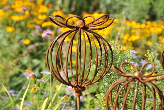 Sculpures complement the colourful borders at Borde Hill Garden near Haywards Heath. Pic S Robards SR2209224