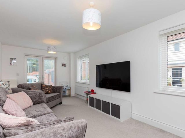 The main sitting room has a light and airy feel due to its triple aspect and double doors opening out onto the landscaped rear garden.