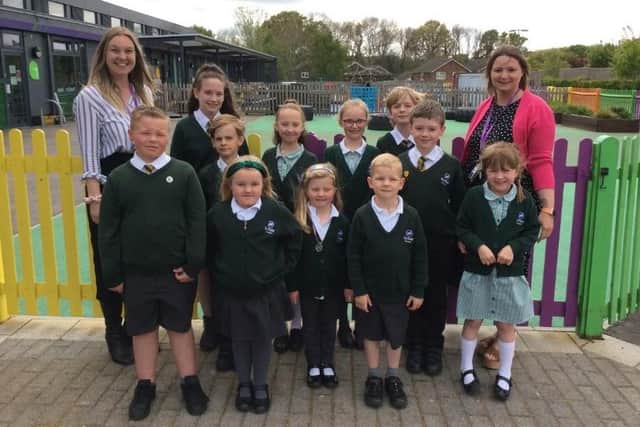 Miss Marshall (assistant headteacher – far left), Mrs Kind (head of school – far right) and a group of Burfield pupils