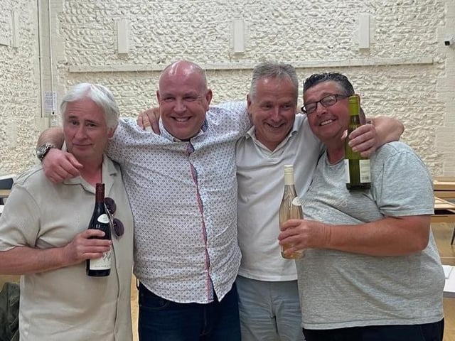 Winners of shuffleboard with sponsor Dean Jones