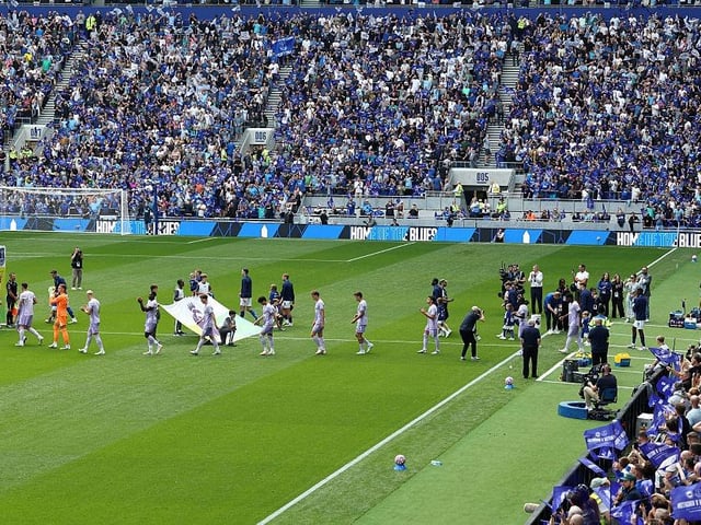 Players walk out onto the pitch ahead of the English Premier League football match between Everton and Brighton and Hove Albion at Hill Dickinson Stadium