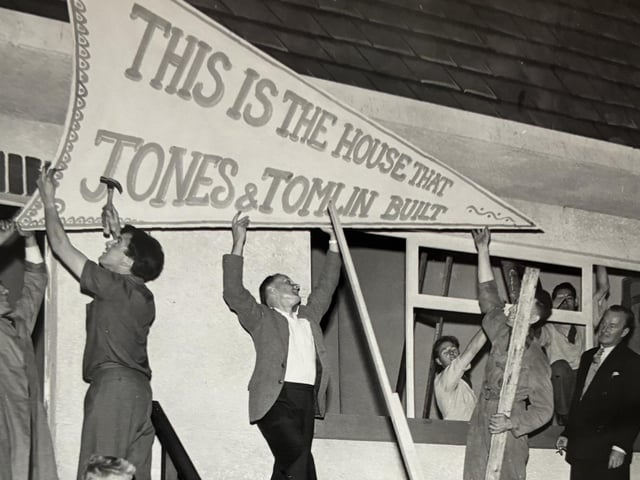 Putting up a display for an exhibition showcasing Jones & Tomlin furniture