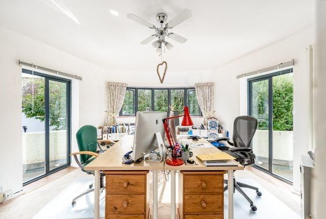 The study/library has double doors opening to the garden.