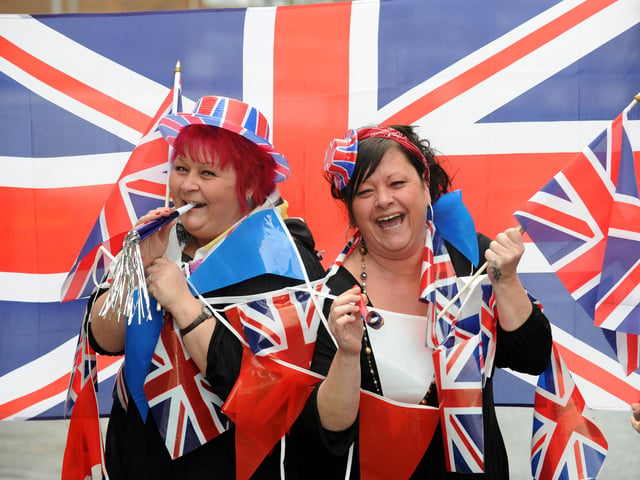 U-Need-Us staff members (l-r) sisters Karen Knipe and Tracey Knipe get the street party started outside the store in February 2011. Picture: Allan Hutchings (110573-296)