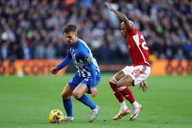 Joel Veltman of Brighton & Hove Albion controls the ball whilst under pressure from Danilo of Nottingham Forest during the Premier League match between Nottingham Forest and Brighton & Hove Albion at City Ground on November 25, 2023 in Nottingham, England. (Photo by Eddie Keogh/Getty Images)