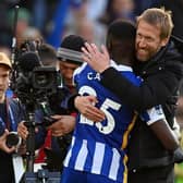 Moises Caicedo gets a big hug from his head coach Graham Potter after Brighton's 4-0 victory against Manchester United