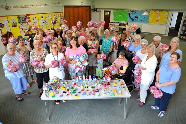 Arcade Knitters presenting more than 3,300 innocent smoothie hats to Age UK West Sussex