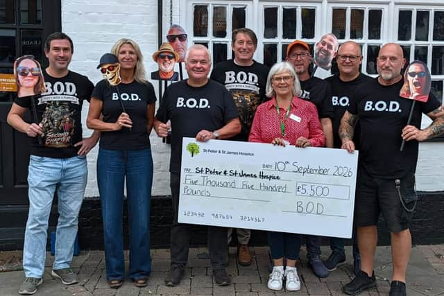 Band of Dads members present their record £5,500 cheque to St Peter & St James Hospice. Photo: Band of Dads