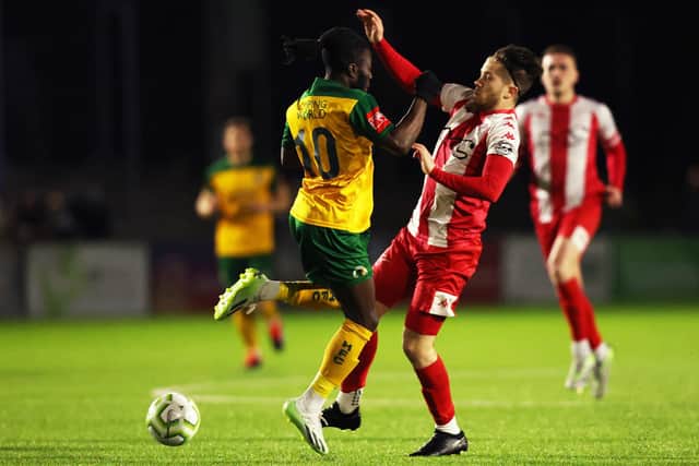 Horsham's Daniel Ajakaiye tangles with a Steyning defender