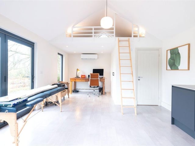 The summer house has a shower room and cloakroom and stairs leading to a mezzanine area.