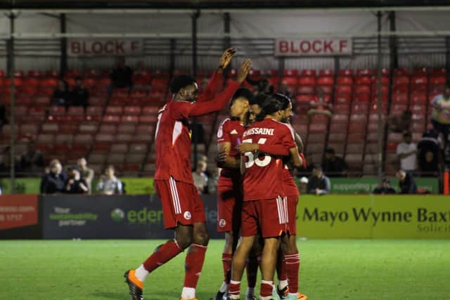 Crawley Town players celebrate with Raf Khaleel, who scored the winning penalty against Portsmouth in the EFL trophy. Picture by Cory Pickford