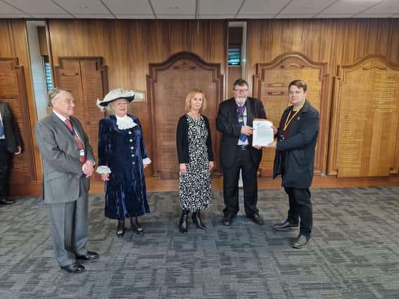Lewes District Councillor Ciarron Clarkson presents his petition with East Sussex County Councillor Christine Robinson, to the Chair of East Sussex County Council Peter Pragnell.