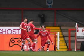 Jordan Tunnicliffe celebrates with teammates Tony Craig and Ashley Nadesan after scoring their team's third goal during the FA Cup Third Round match between Crawley Town and Leeds United at The Peoples Pension Stadium on January 10, 2021