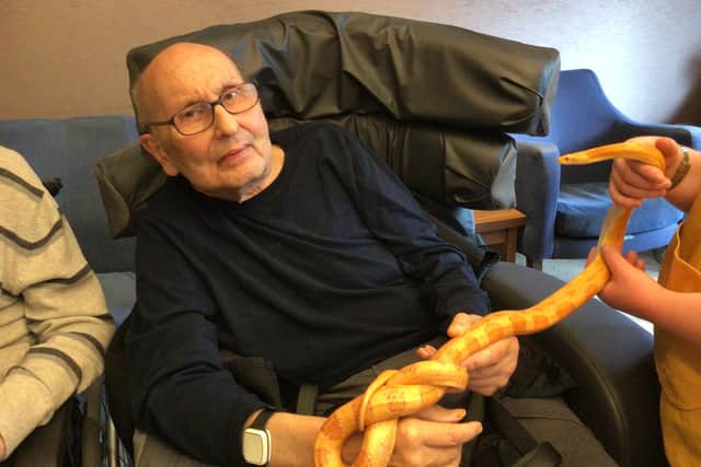Residents at The Goldbridge Bupa Care Home in Haywards Heath have recently enjoyed a visit from an array of animals including a giant African snail, snakes, and gerbils. Picture: The Goldbridge Care Home
