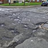 Pot hole scarred road at the junction of Winchelsea Road and Rock Lane in Hastings.