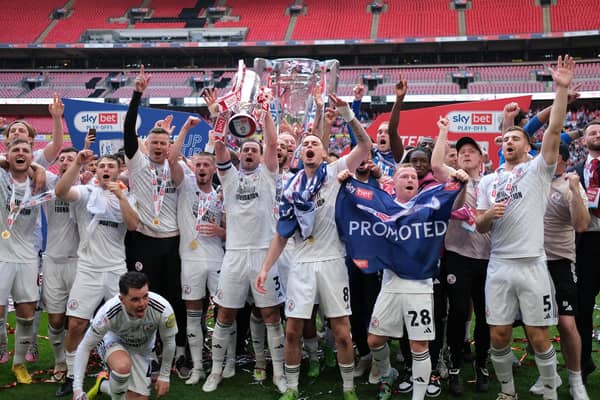 LONDON, ENGLAND - MAY 19: Players of Crawley Town celebrate with the Sky Bet League Two Play-Off Final trophy after the team's victory in the Sky Bet League Two Play-Off Final match between Crawley Town and Crewe Alexandra at Wembley Stadium on May 19, 2024 in London, England. (Photo by Paul Harding/Getty Images)