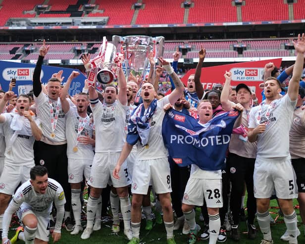 LONDON, ENGLAND - MAY 19: Players of Crawley Town celebrate with the Sky Bet League Two Play-Off Final trophy after the team's victory in the Sky Bet League Two Play-Off Final match between Crawley Town and Crewe Alexandra at Wembley Stadium on May 19, 2024 in London, England. (Photo by Paul Harding/Getty Images)