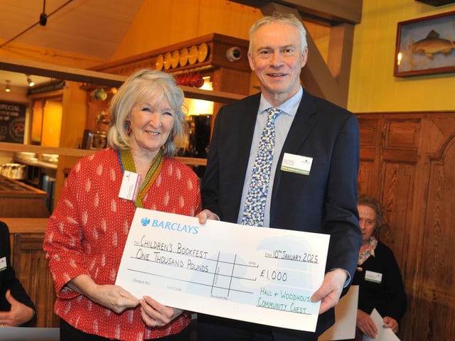 Children’s BookFest founder Penny Tomlinson with judge Gary Shipton, receiving £1,000 towards books for the Bognor festival in February