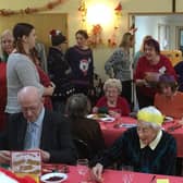 Photo caption: Festive fun . . . . the party in full swing at a previous rotary Christmas Day lunch.