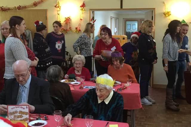Photo caption: Festive fun . . . . the party in full swing at a previous rotary Christmas Day lunch.