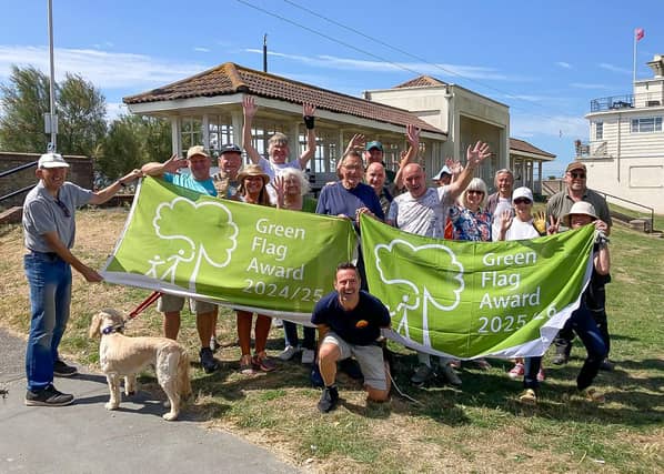 The Friends of Denton Gardens celebrating with members of the council's parks team at the green space in Worthing