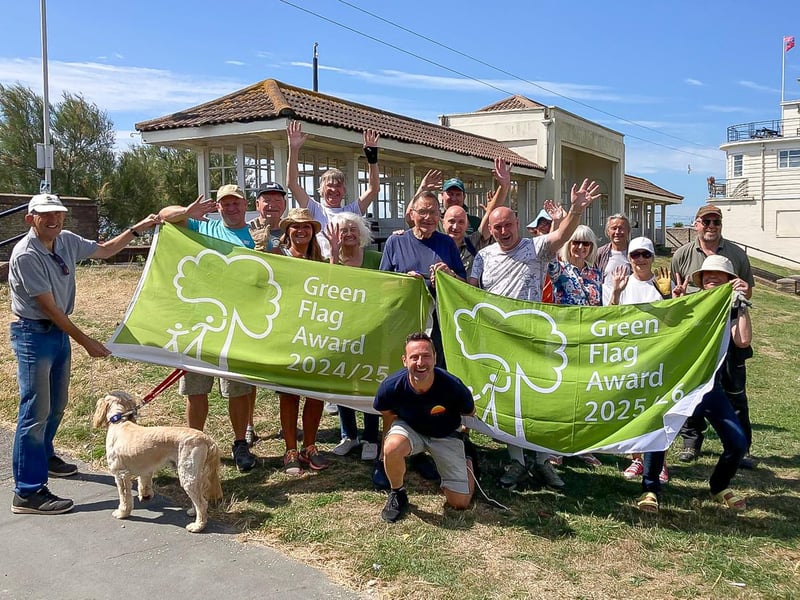 The Friends of Denton Gardens celebrating with members of the council's parks team at the green space in Worthing