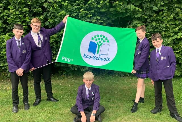 Students with Eco-schools flag