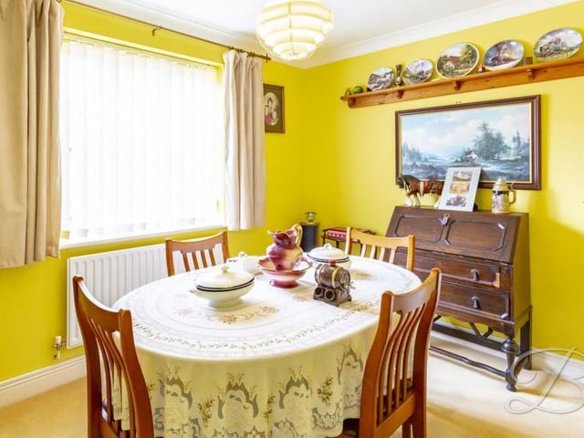 The dining room is a quaint part of the Spindle Court house, offering more space for hosting or simply a quiet corner for family meals. It has a carpeted floor, central heating radiator and a window facing the front.