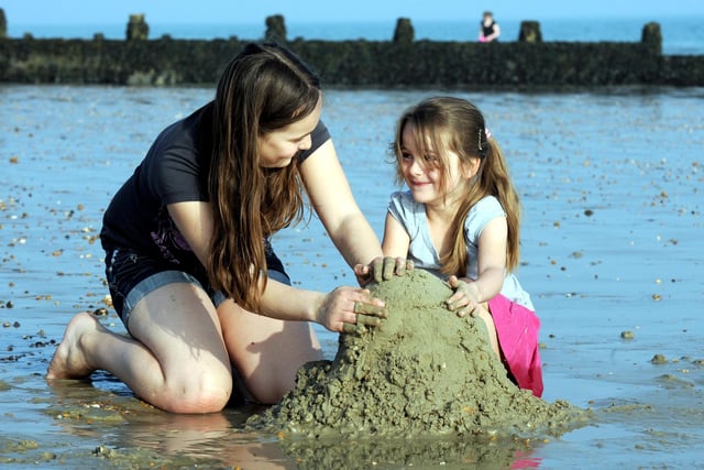 Millie Hedgcock Dawes and Jessica Smith making sandcastles