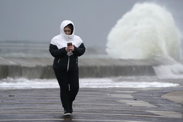 A person makes their way along the seafront in Southsea as Storm Barra hit. Picture: Andrew Matthews/PA Wire