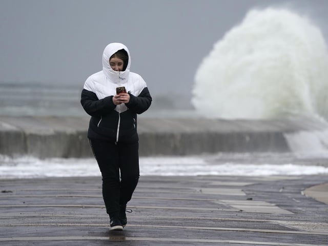 A person makes their way along the seafront in Southsea as Storm Barra hit. Picture: Andrew Matthews/PA Wire