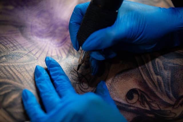 New data has revealed tattoo parlours are on the rise in Eastbourne since the pandemic (Photo by NICOLAS ASFOURI/AFP via Getty Images)